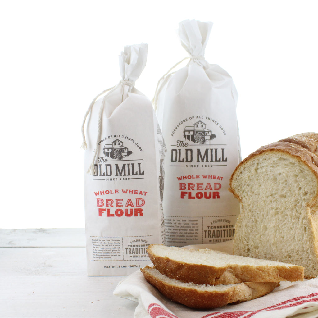 a loaf of fresh bread flour product in a bird's nest on a wooden